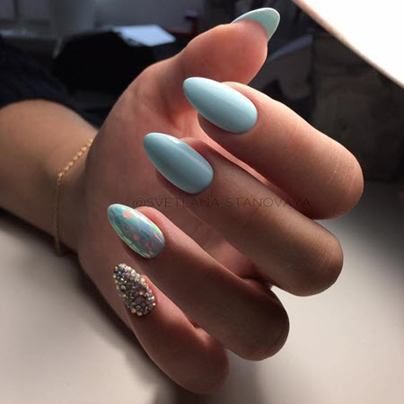 Foto de manicura azul para uñas largas en forma de almendra.